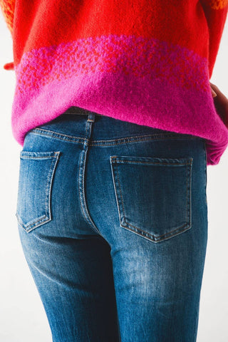 Flared jeans with raw edge in mid wash: Blue