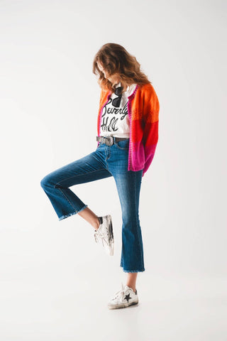 Flared jeans with raw edge in mid wash: Blue