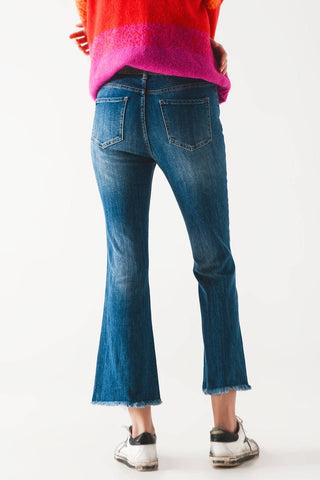 Flared jeans with raw edge in mid wash: Blue